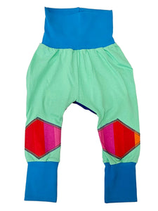 Colorful baby harem pants with geometric patterns on a white background